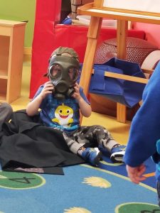 Toddler wearing a gas mask