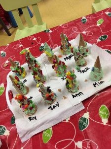 Christmas cones on a table with toddler's names 