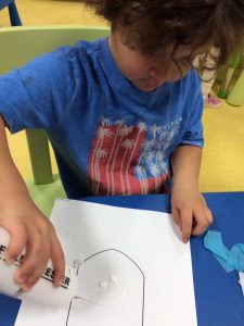 Toddler enjoying himself with a dreidel outline