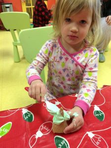 Toddler making a christmas cone