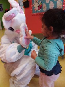 Toddler giving the easter bunny a high five