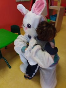 Kid giving the easter bunny a hug