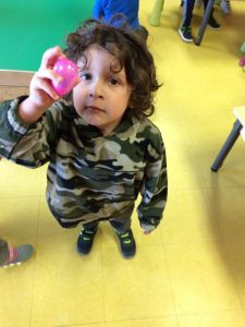 Toddler holding his pink easter egg