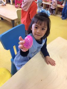 Toddler showing off their easter egg