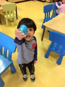 Toddler holding up his easter egg