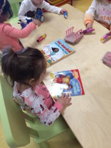 Kids looking at a book