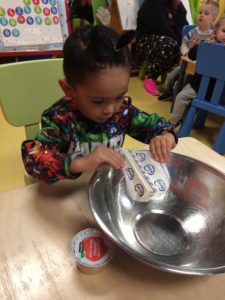 Kid adding ingredients to the bowl