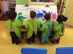 Little kids painting all together 