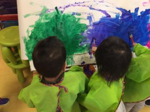 Children painting with lots of colours