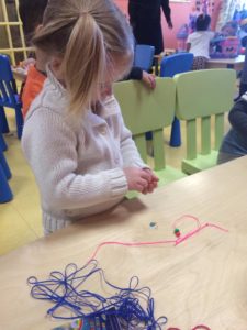 Little kid sorting beads