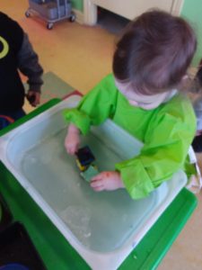 Kid washing a toy car