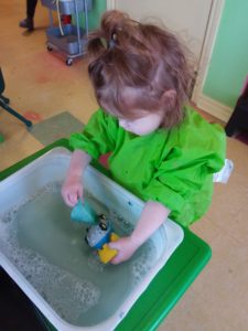 Kid learning how to wash a toy car