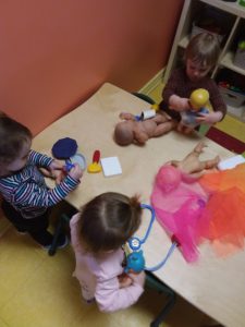 Kids with toy stethoscopes playing with toy babies