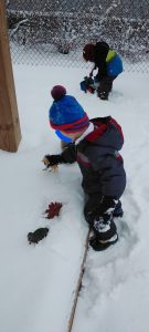 Toddlers playing in a snow field