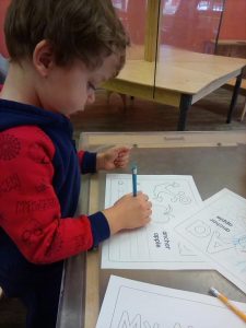 Toddler writing the alphabet 