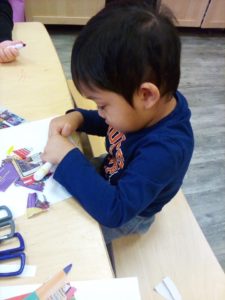 Toddler doing playing with arts and crafts 