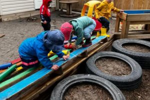 Toddlers playing on an obstacle course