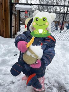 Infant playing with snow