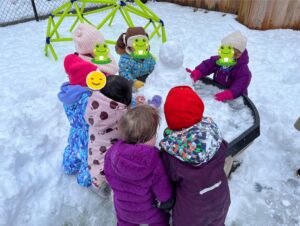A group of children playing with snow