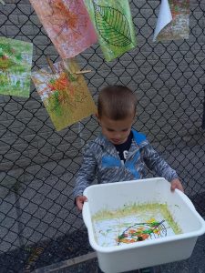 Kid with a bin full of artwork