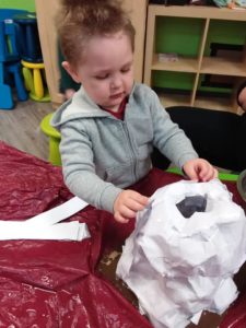 Kid touching a science experiement volcano