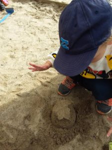 Toddlers having lots of fun in the sand