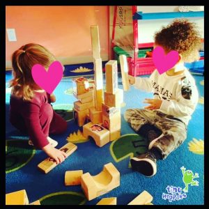 Toddlers building a structure with building blocks