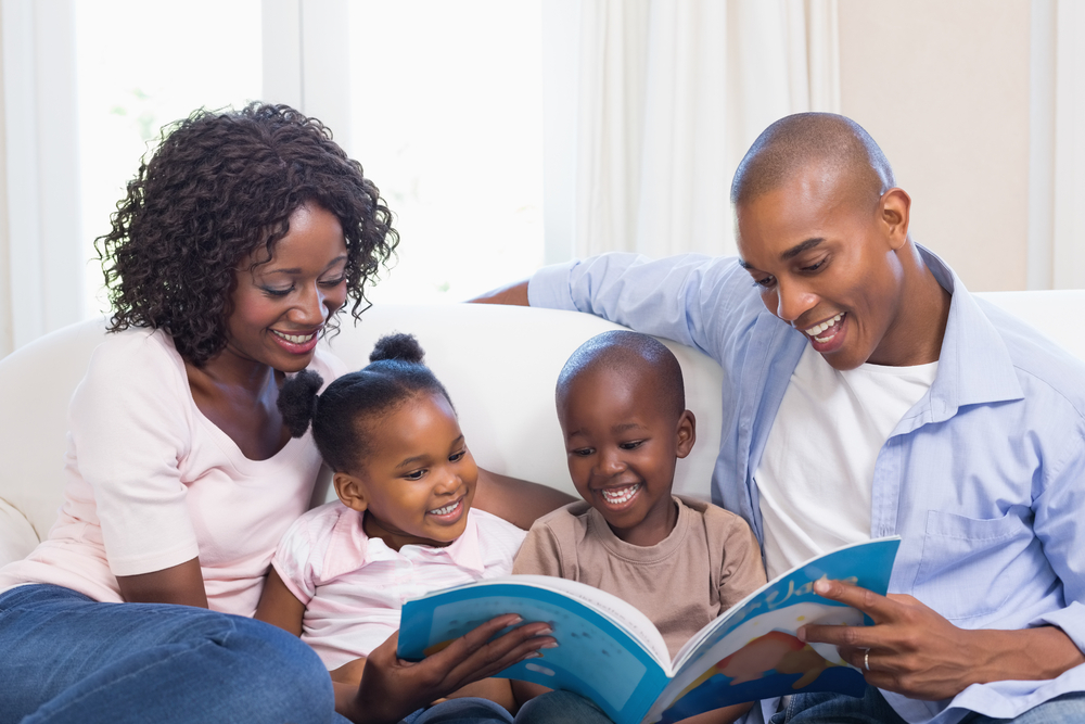 A mother and father read to their two children