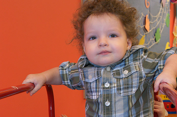 A little boy plays on a slide