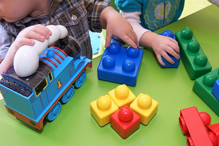 Close-up of children playing with toys