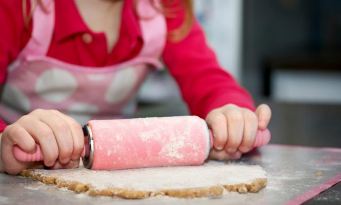 A child uses a rolling pin