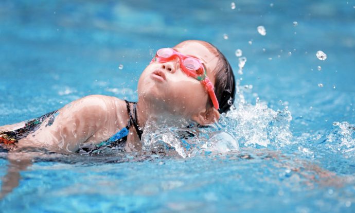 A child swims in an indoor pool