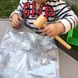 kid playing with ice