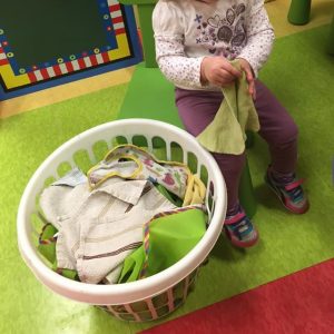 child folding laundry